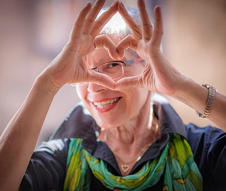 Woman making a heart with her fingers around her eye