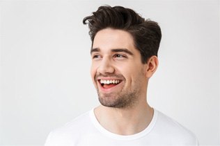 a man smiling after getting cosmetic dentistry
