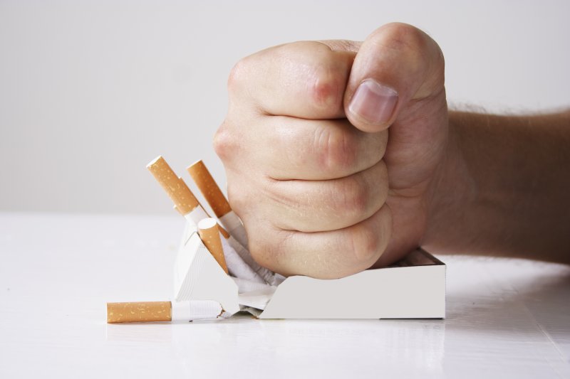 Man crushing cigarettes