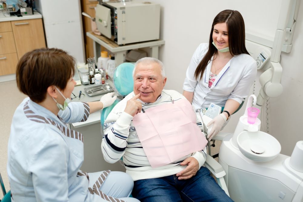 A man at the dentist undergoing dental implant surgery